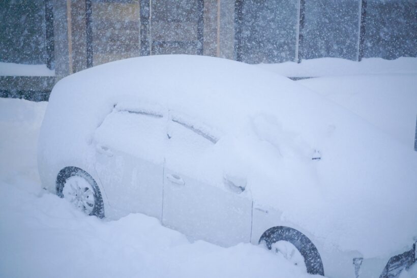 雪で埋もれている車の写真