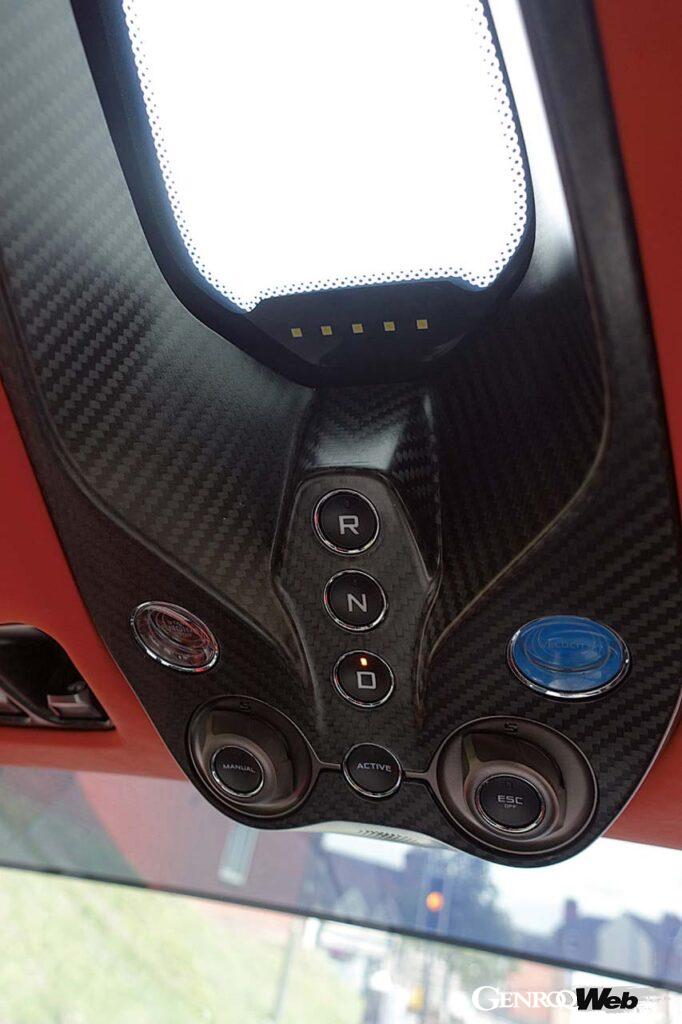 センターコンソールがないため、エンジンスタートやシフトなどのボタンは頭上に位置する。青いボタンは最大性能を発揮させるベロシティモードスイッチだ。